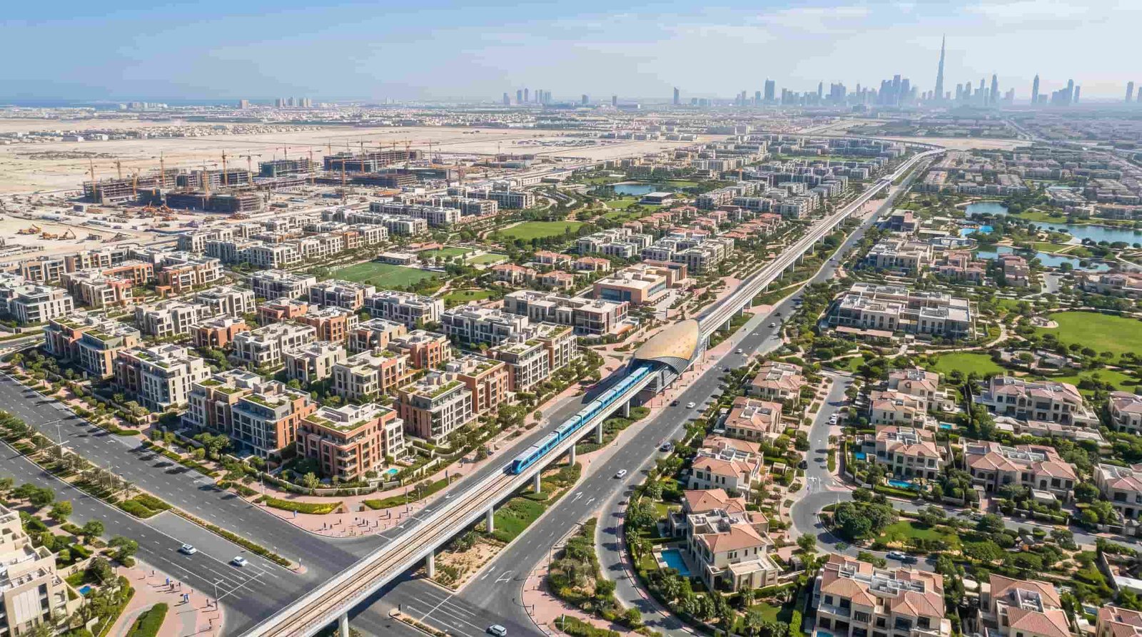 Aerial view of a planned Dubai residential community with new homes under construction