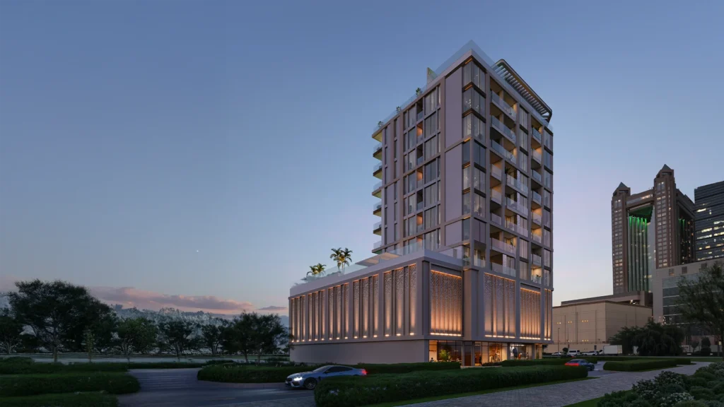 Boutique low-rise Dubai residential tower at dusk with illuminated podium and landscaped grounds